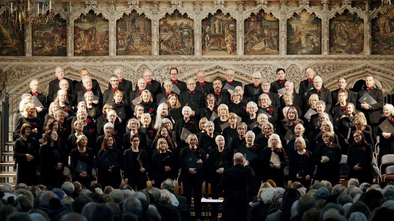 A packed choir performing to a full audience