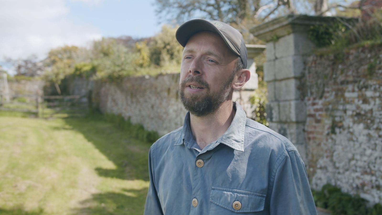 A business owner talking outside his walled garden