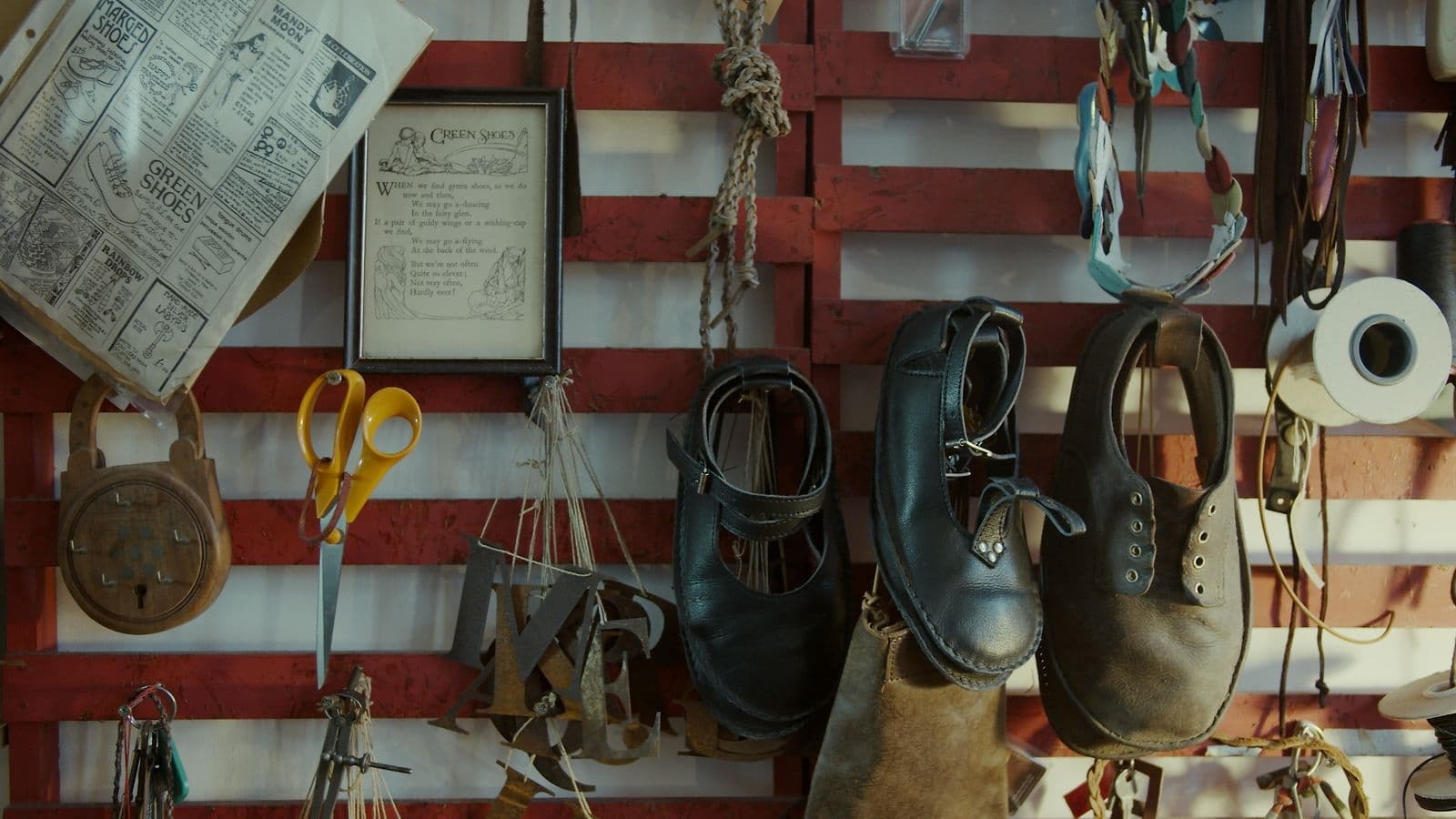 A shoemaker's workshop wall of tools and boots